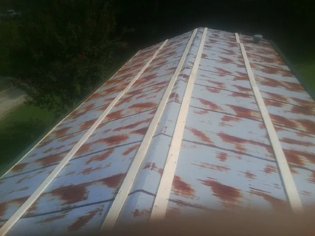 Rusted metal roof panels with new wood purlins before replacement — Storm Damage Roof Repair in Peckville by Roofing Brothers